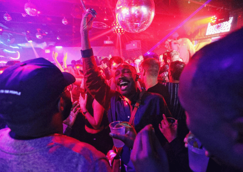 People dancing under the disco ball at Outer Heaven, a night club in austin