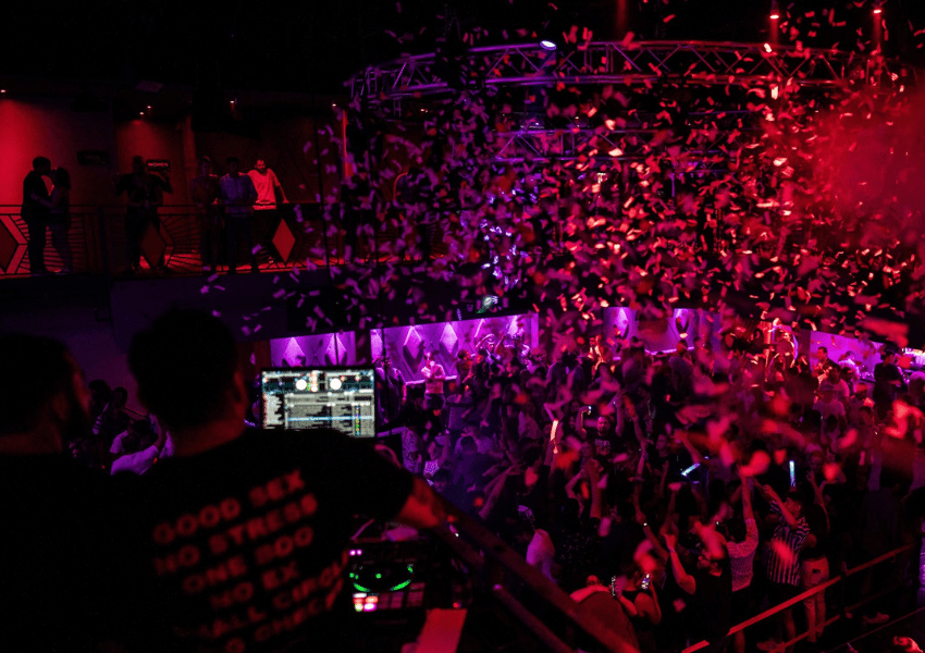 Rose Room one of the night clubs in north austinnthrowing confetti on the crowd dancing at