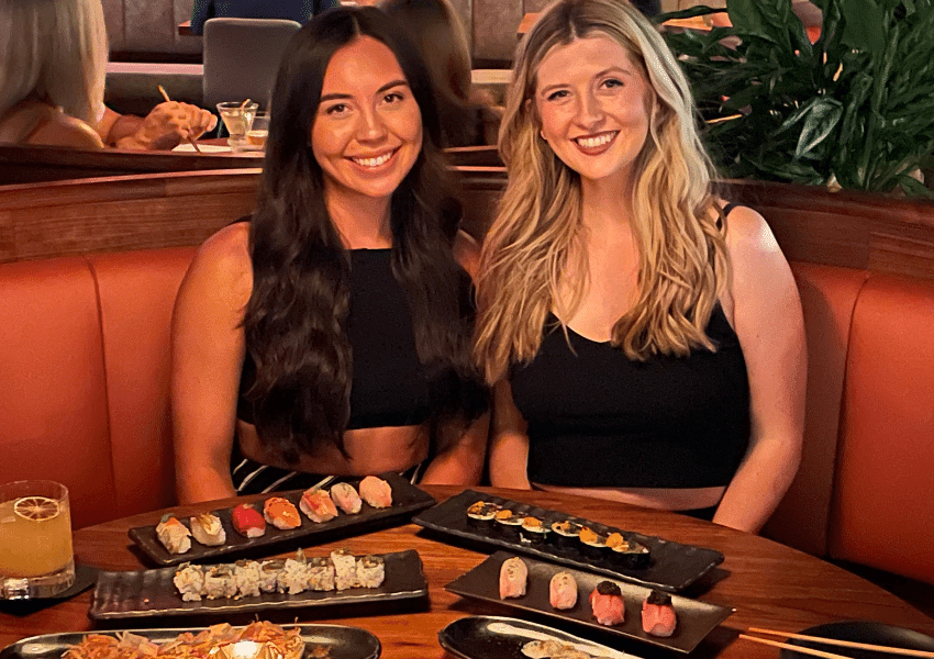 Girls eating sushi at TenTen - best sushi in. Austin